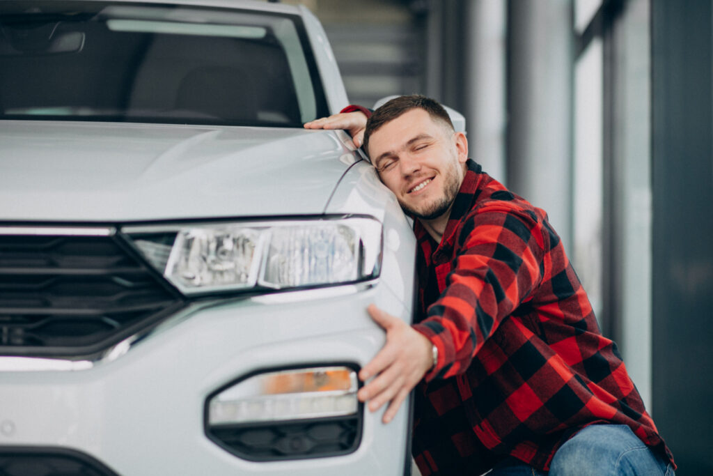 Man looking happing after seeing his used car