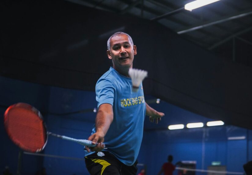man in blue crew neck t-shirt and black shorts holding red basketball